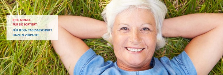 Frau liegt im Gras